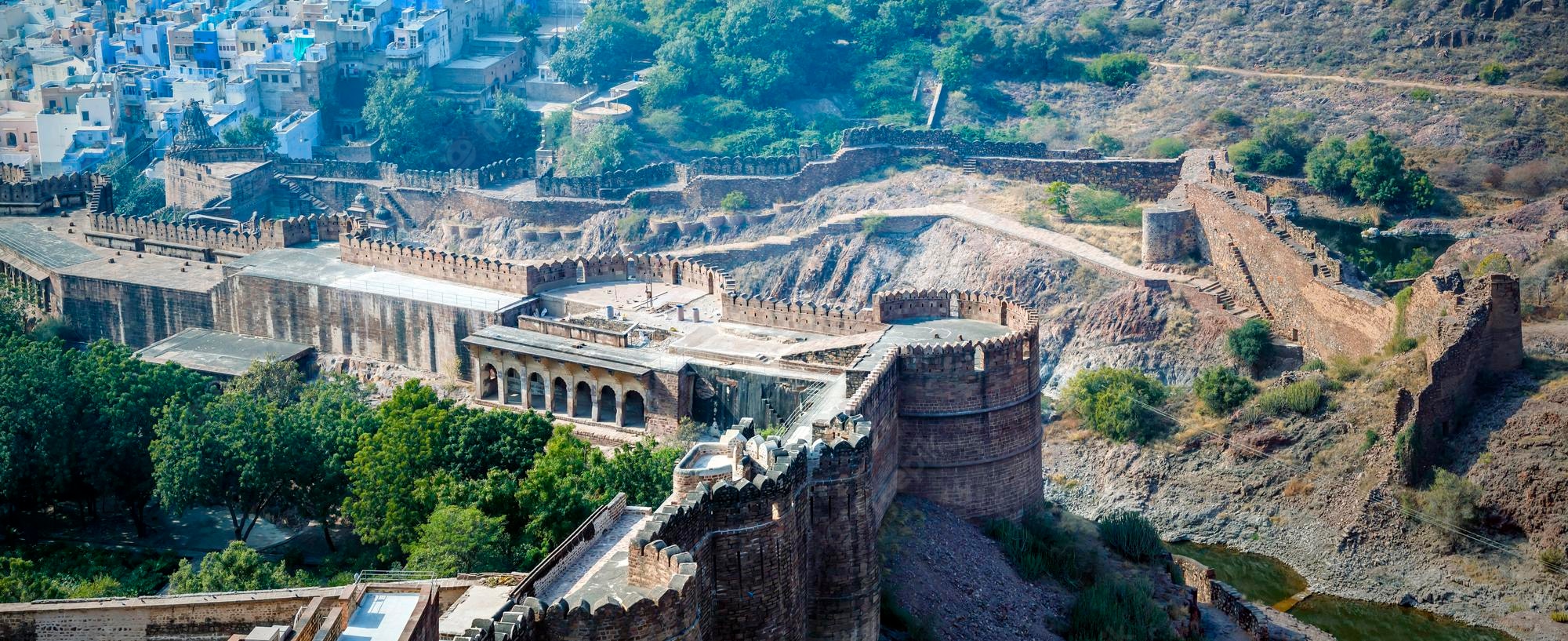 Mehrangarh Fort ramparts and towers overlooking Jodhpur's blue-painted houses on a rocky hillside
