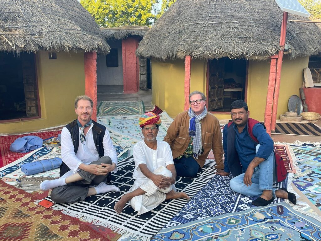 A group of tourists exploring a fort in Rajasthan with a guide from My India Cab Service.