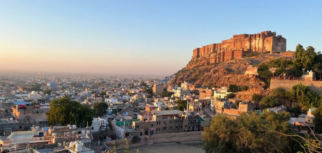A stunning shot of Mehrangarh Fort towering over the blue houses of Jodhpur at sunrise